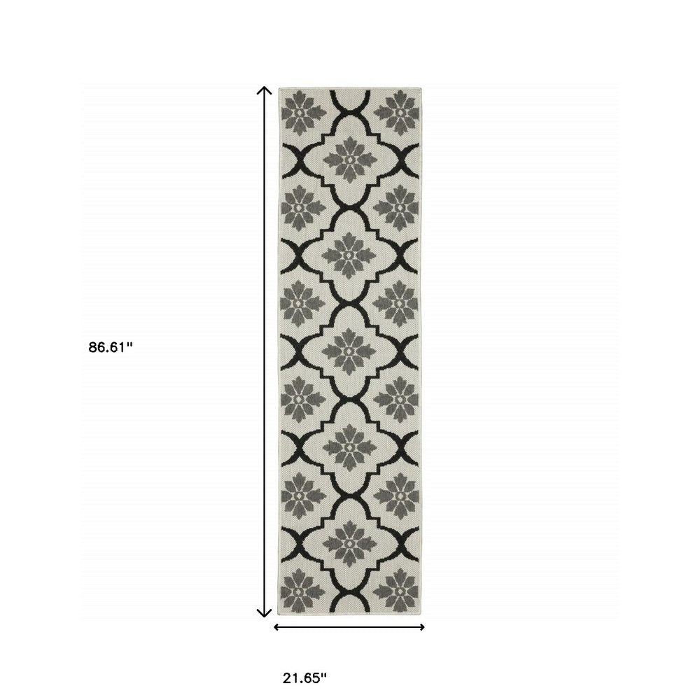 2' X 7' Beige and Black Geometric Stain Resistant Indoor Outdoor Area Rug