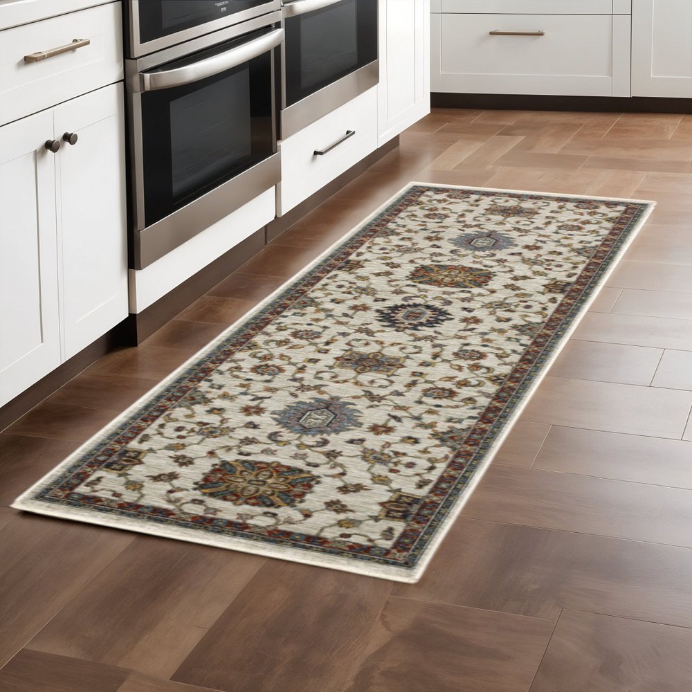 2' X 8' Beige Rust Red Blue Gold And Grey Oriental Power Loom Stain Resistant Runner Rug With Fringe