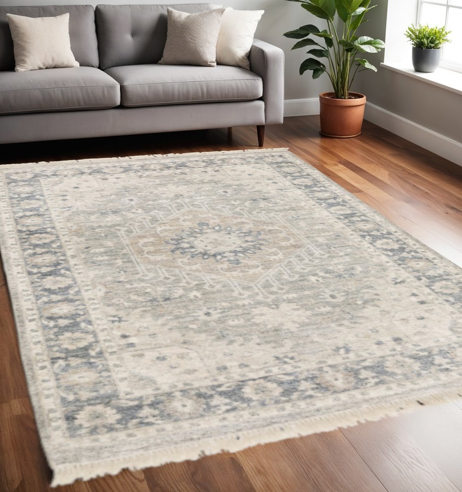 5' X 8' Beige And Grey Oriental Hand Loomed Stain Resistant Area Rug With Fringe