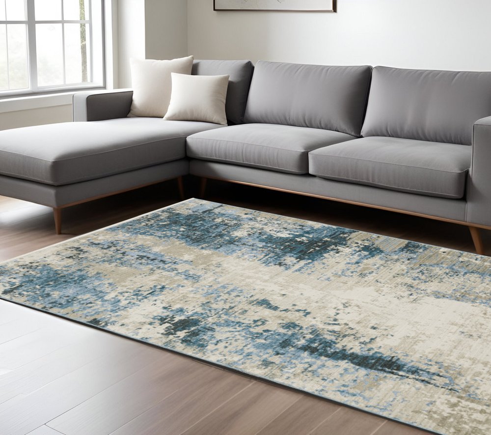 10' X 13' Blue Grey Ivory Light Blue And Dark Blue Abstract Power Loom Stain Resistant Area Rug With Fringe