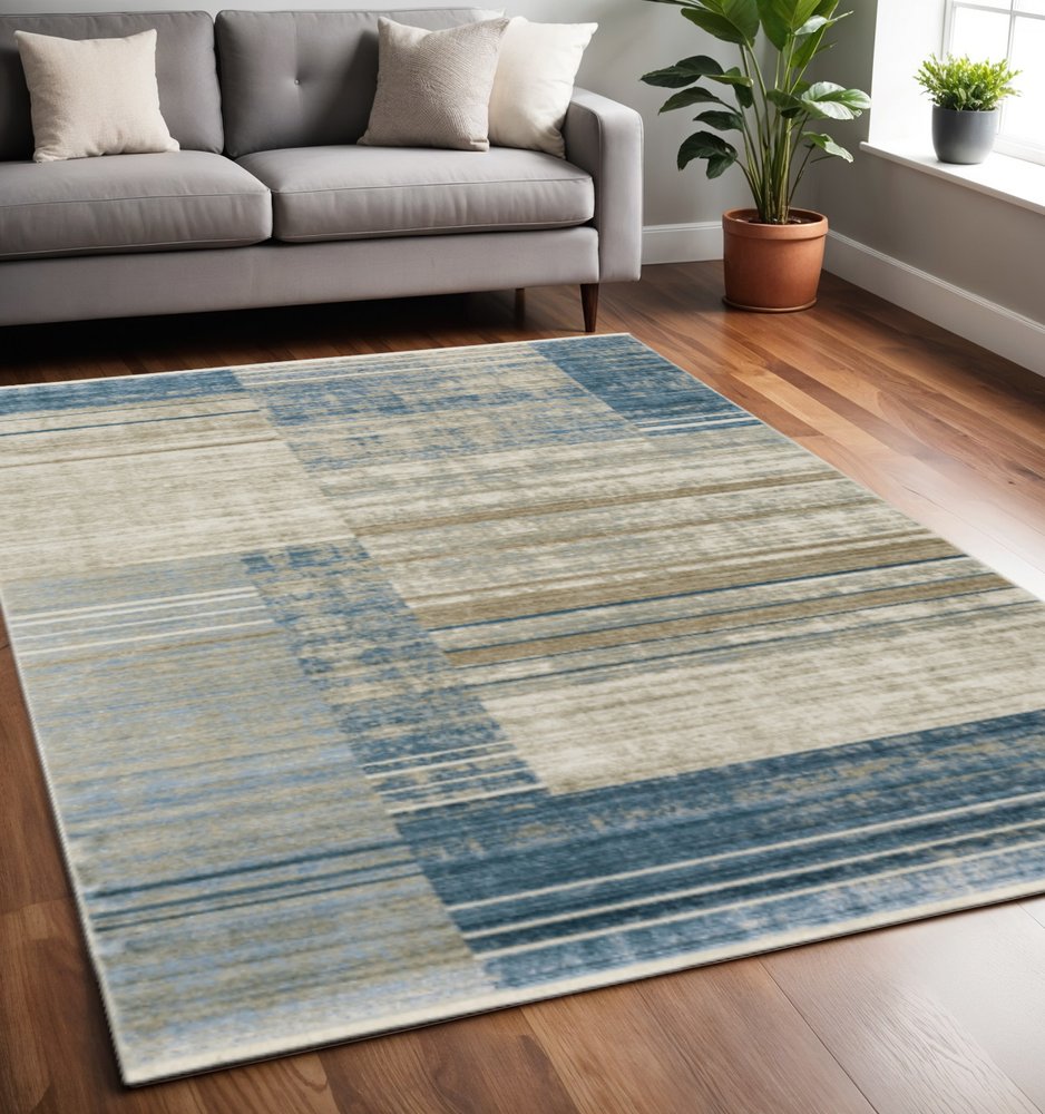 5' X 8' Blue Dark Blue Teal Grey Ivory Beige And Tan Geometric Power Loom Stain Resistant Area Rug With Fringe
