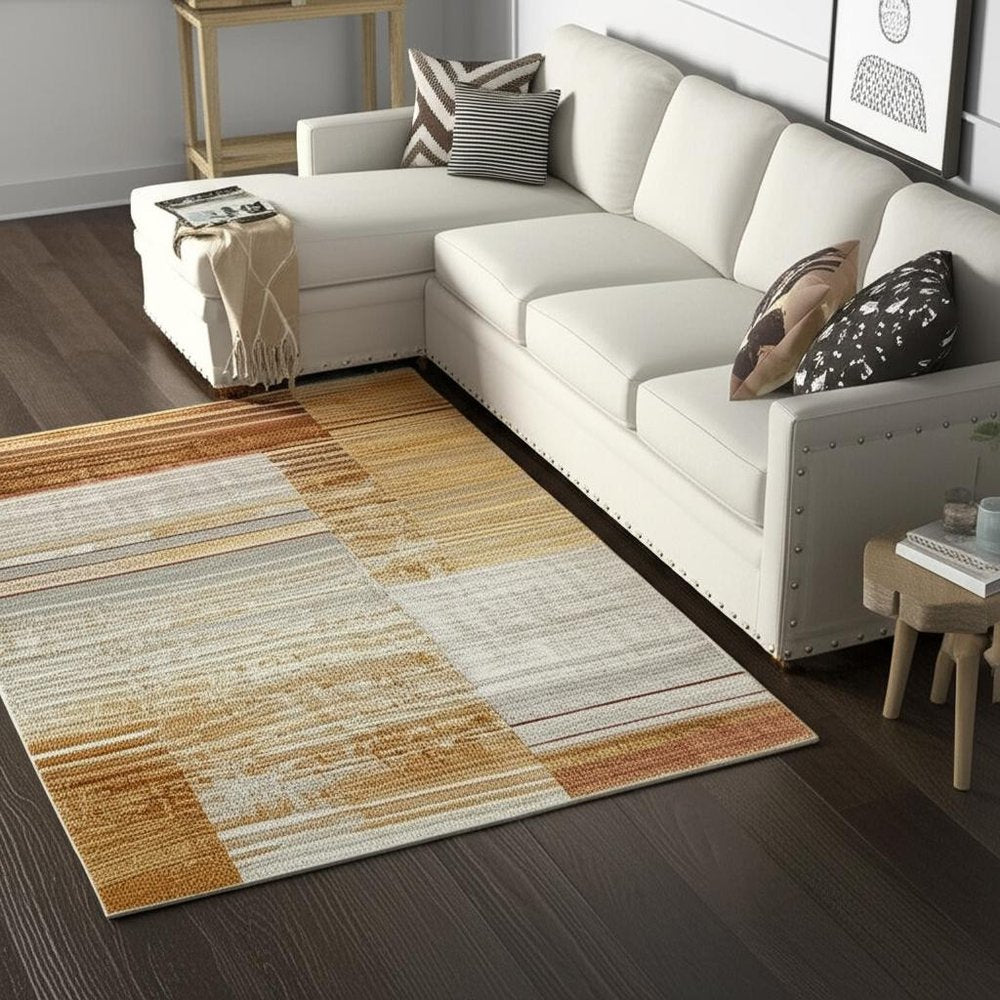 5' X 8' Rust Gold Blue Grey Ivory And Tan Geometric Power Loom Stain Resistant Area Rug With Fringe