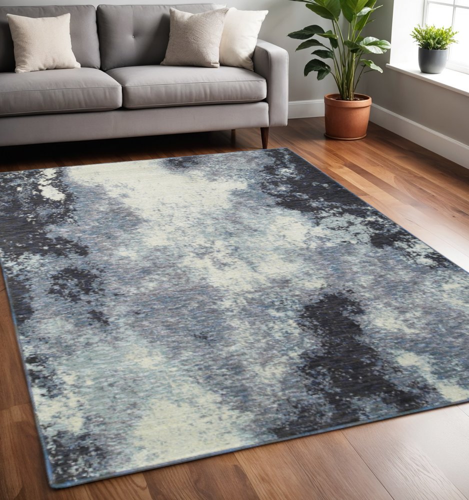 5' X 7' Blue and Ivory Abstract Power Loom Area Rug
