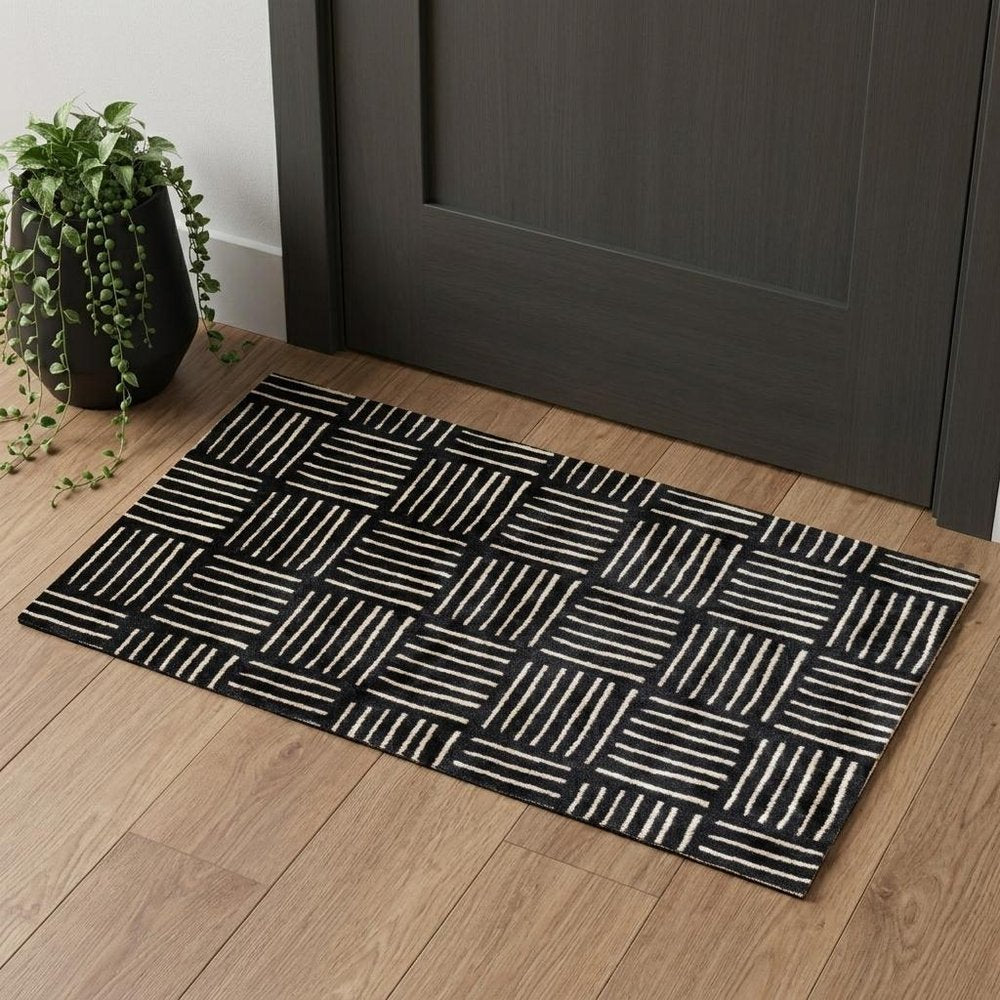 2' X 4' Black and Off White Abstract Machine Tufted Washable Area Rug With UV Protection