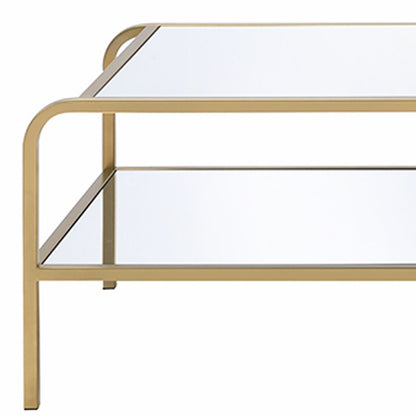 52" Clear and Gold Mirrored Glass And Iron Coffee Table With Shelf