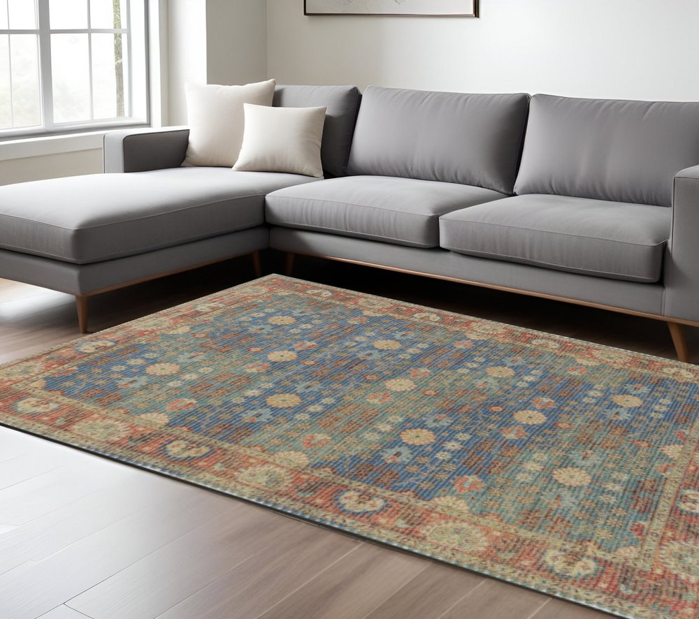 5' X 7' Blue Red And Beige Floral Medallion Hand Woven Distressed Area Rug