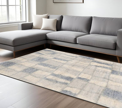 5' X 8' Ivory And Blue Abstract Area Rug