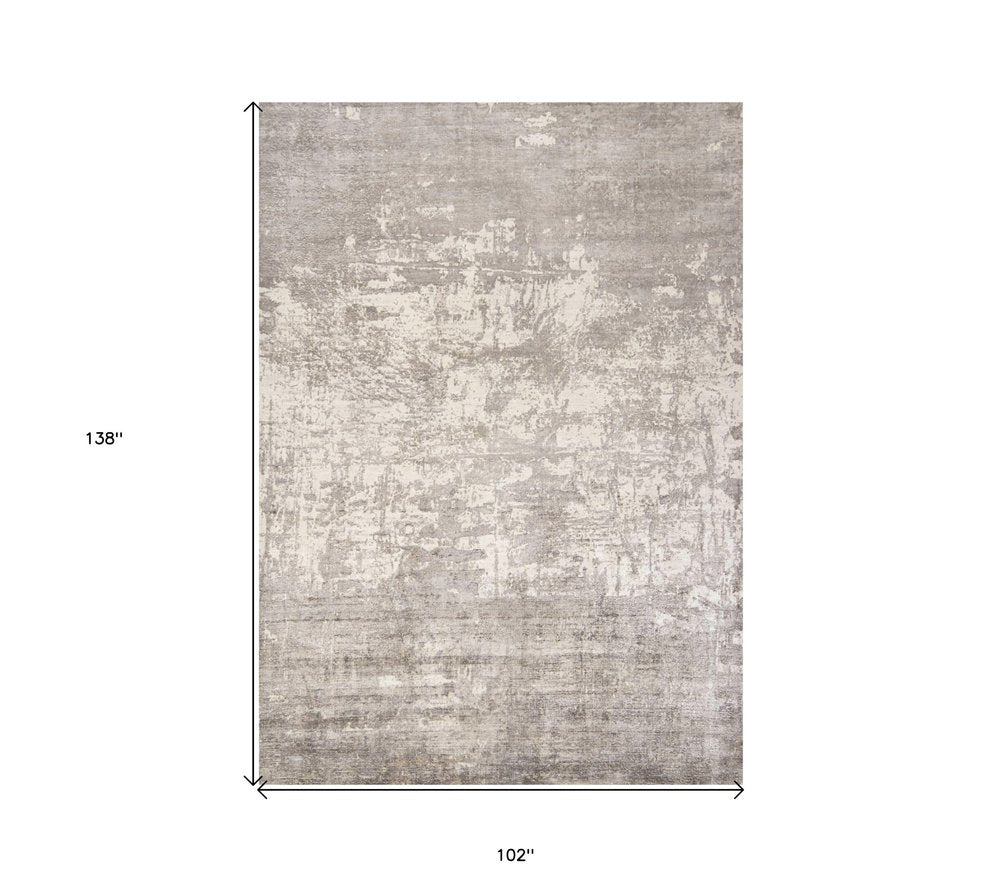 7' X 10' Beige And Ivory Abstract Hand Loomed Area Rug