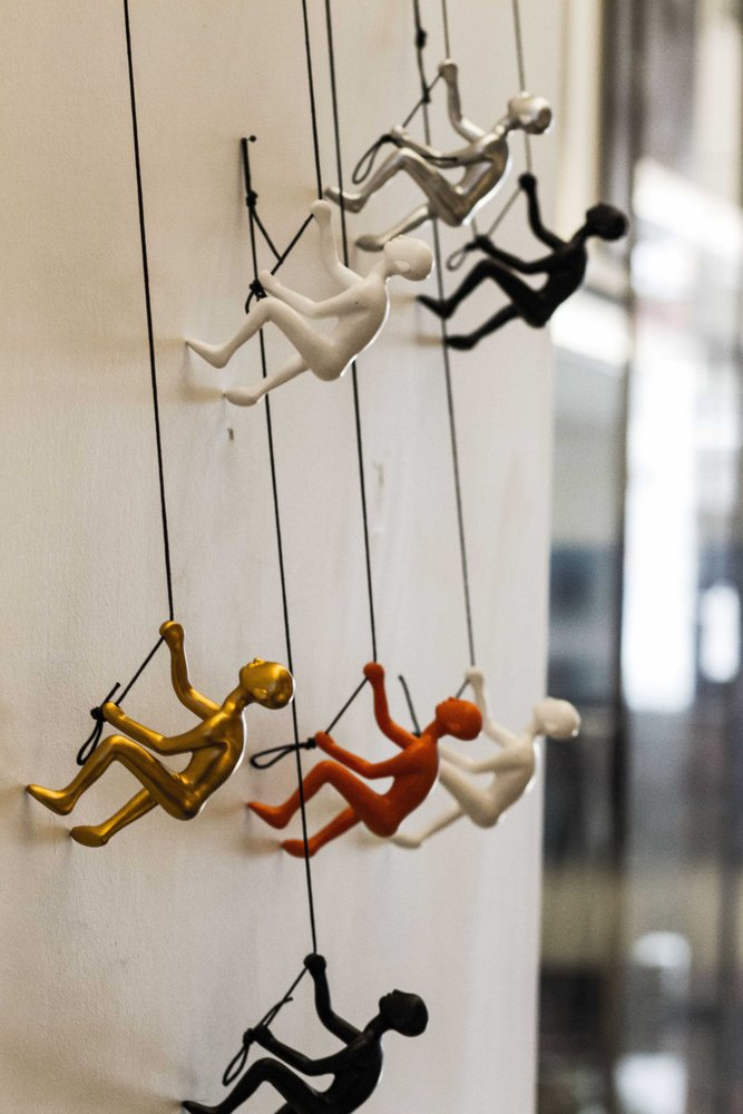 Set of Nine Rainbow Resin Climbing Man Hanging Dimensional Sculpture