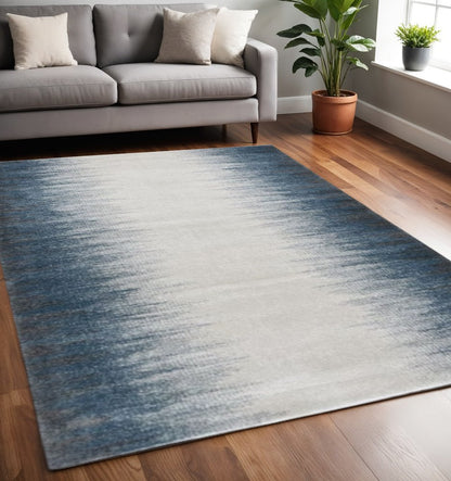 5' X 8' Ivory And Blue Abstract Area Rug