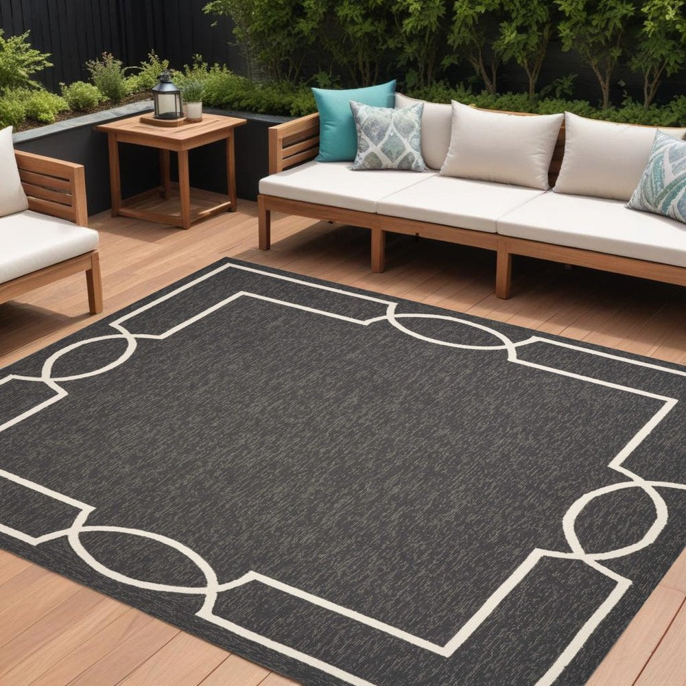 7' X 10' Onyx And White Geometric Handmade Indoor Outdoor Area Rug