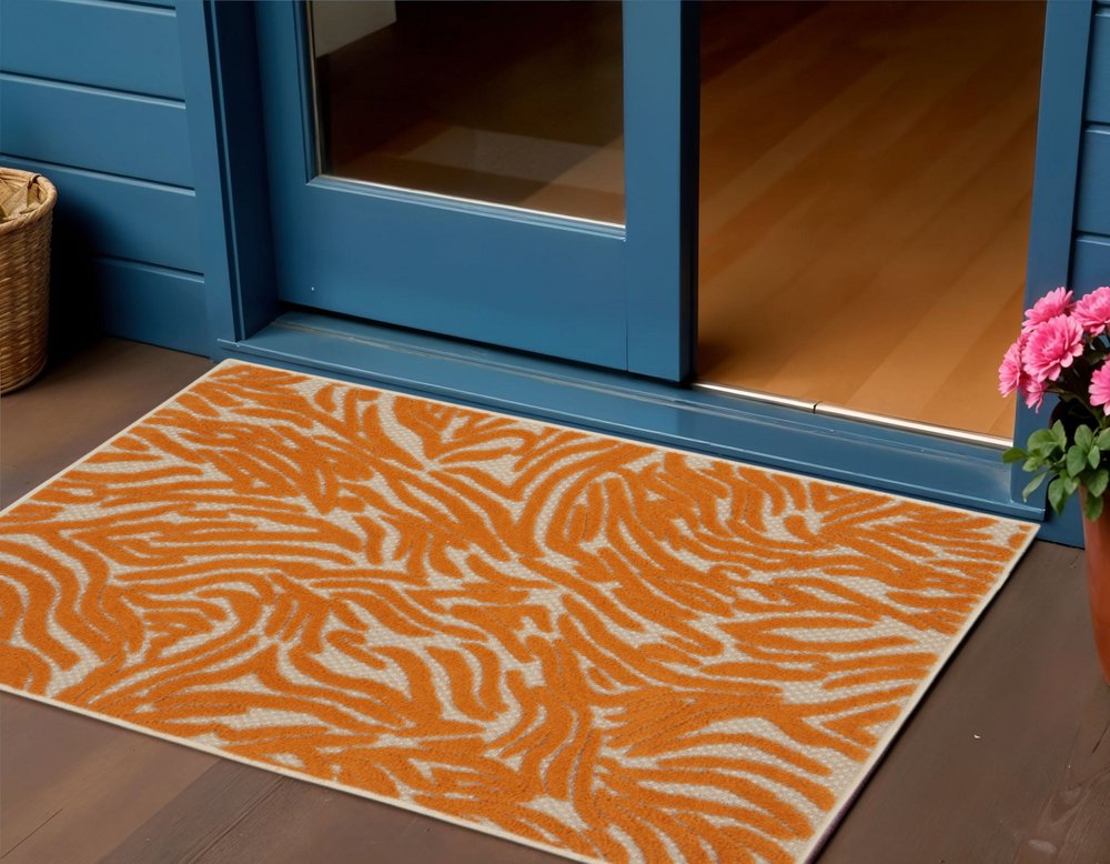 3' X 4' Orange And Ivory Abstract Indoor Outdoor Area Rug