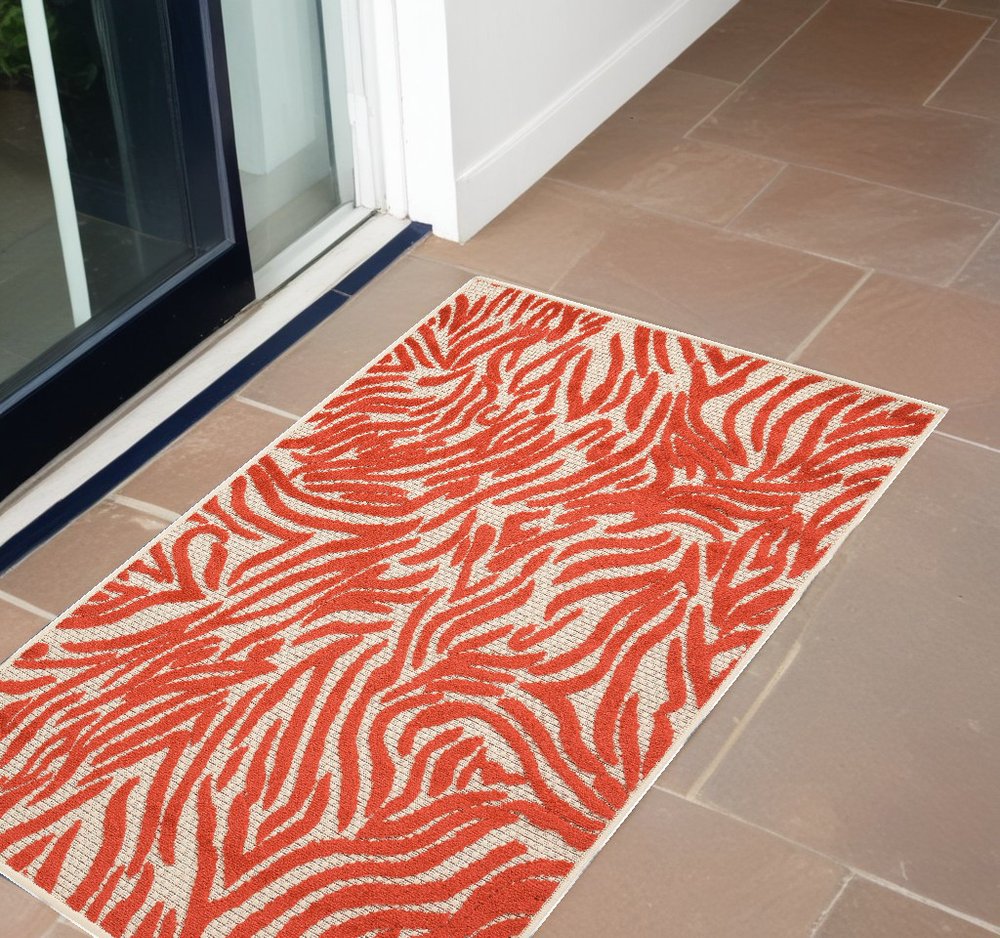 3' X 4' Orange And Ivory Abstract Indoor Outdoor Area Rug