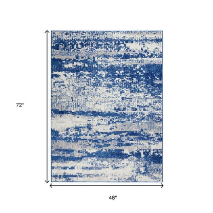 6' X 9' Ivory And Blue Ombre Distressed Area Rug