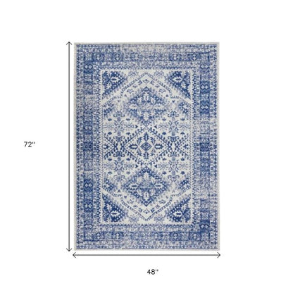 4' X 6' Ivory And Blue Geometric Distressed Area Rug