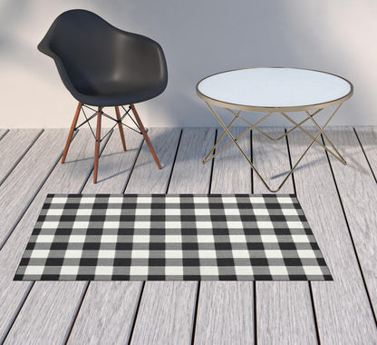 2' X 4' Black and Ivory Indoor Outdoor Area Rug