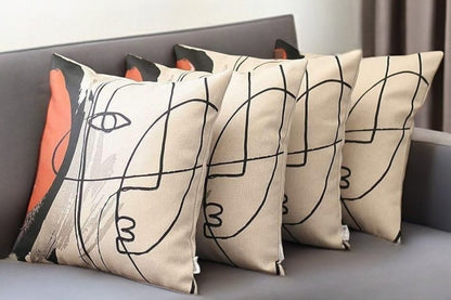 Set of Four 18" Ivory Black and Red Abstract Face Fabric Throw Pillows