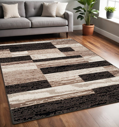 5' X 8' Black Brown And Beige Patchwork Area Rug