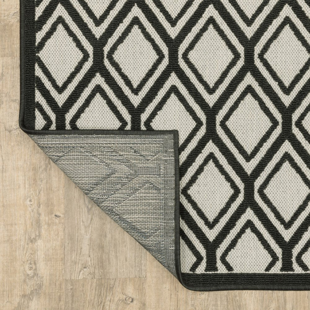 7' X 9' Beige and Black Geometric Stain Resistant Indoor Outdoor Area Rug
