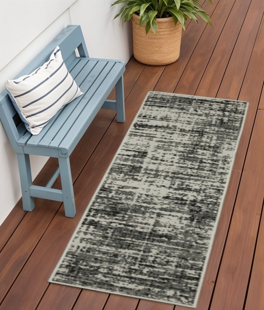 2' X 7' Beige and Black Abstract Stain Resistant Indoor Outdoor Area Rug