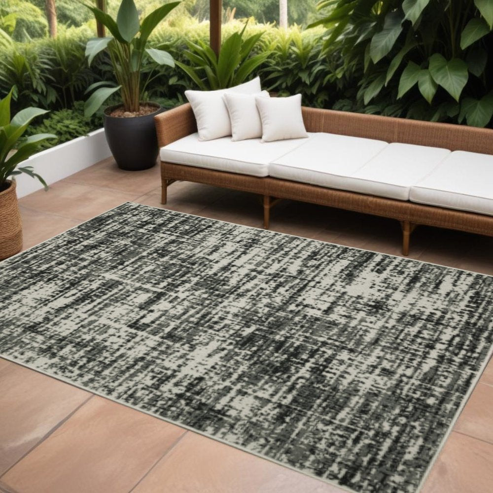 7' X 9' Beige and Black Abstract Stain Resistant Indoor Outdoor Area Rug