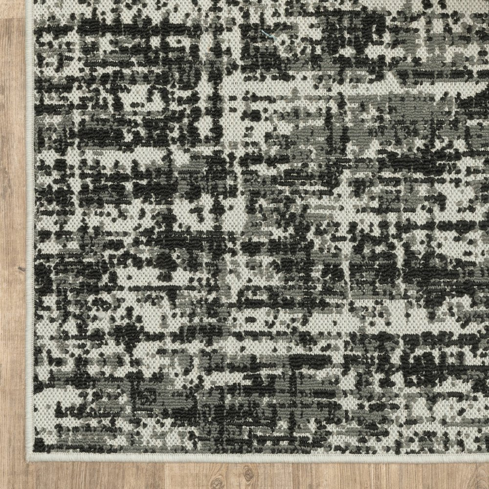 7' X 9' Beige and Black Abstract Stain Resistant Indoor Outdoor Area Rug