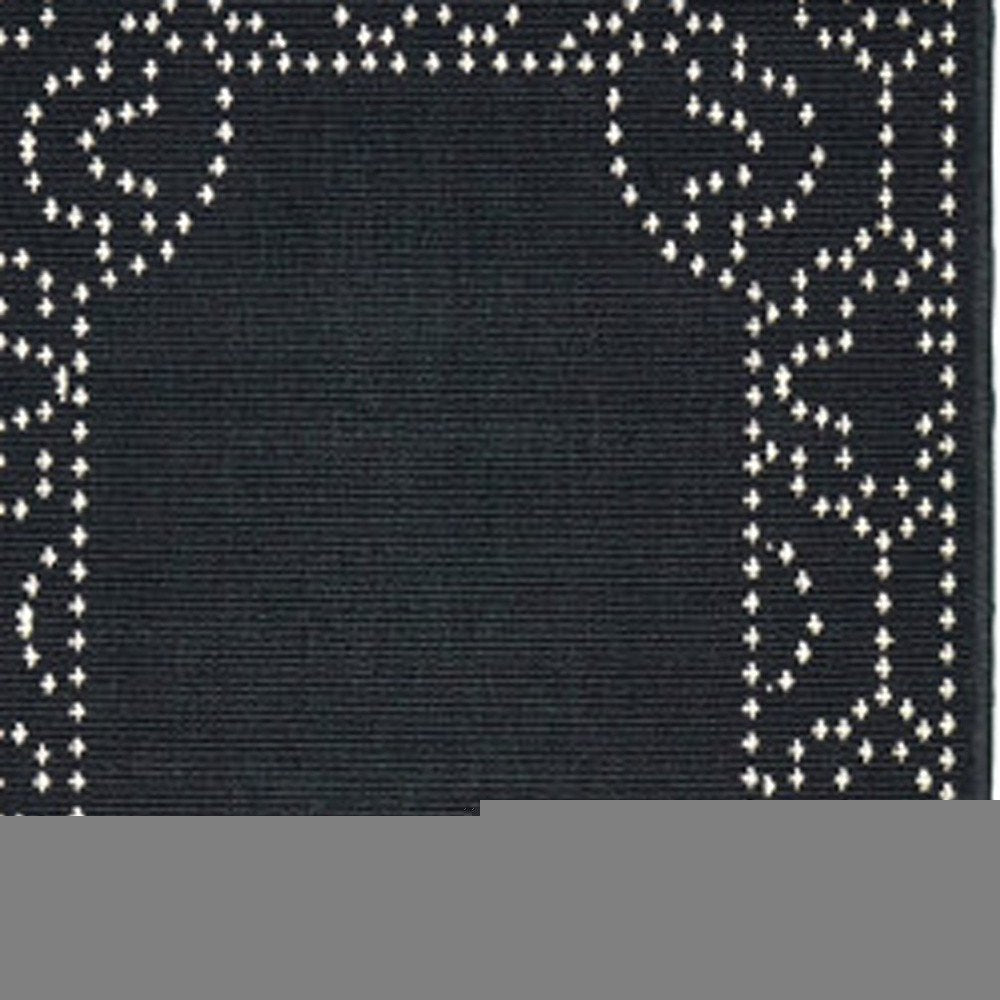 2' X 8' Black and Ivory Stain Resistant Indoor Outdoor Area Rug