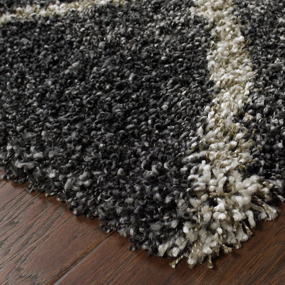 5' X 8' Charcoal And Grey Geometric Shag Power Loom Stain Resistant Area Rug