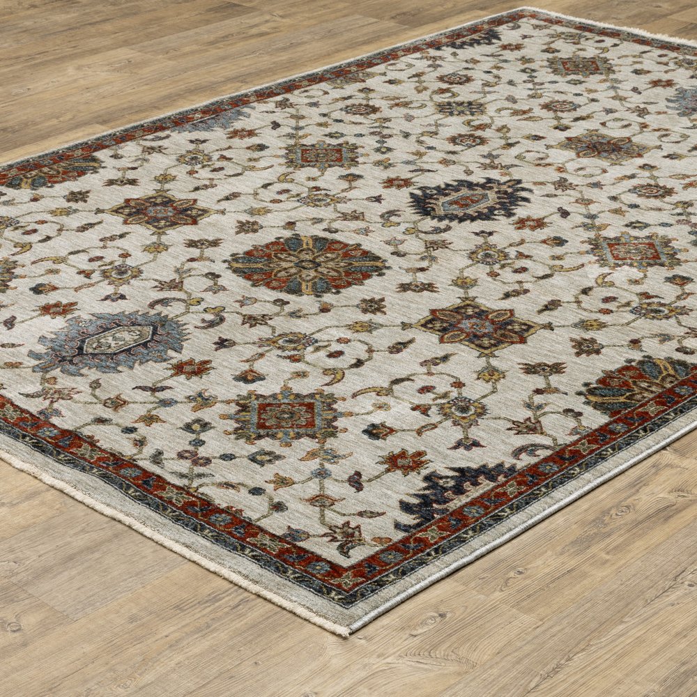 10' X 13' Beige Rust Red Blue Gold And Grey Oriental Power Loom Stain Resistant Area Rug With Fringe