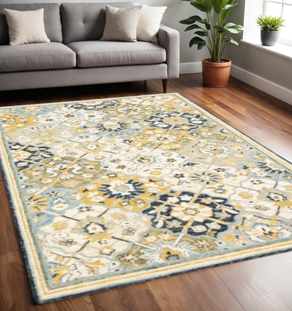 5' X 8' Blue Green Gold Navy And Ivory Geometric Tufted Handmade Stain Resistant Area Rug