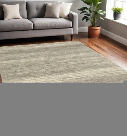 5' X 8' Grey Beige And Tan Abstract Power Loom Stain Resistant Area Rug