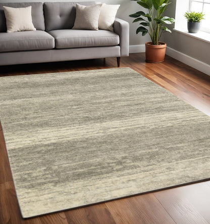 5' X 8' Grey Beige And Tan Abstract Power Loom Stain Resistant Area Rug