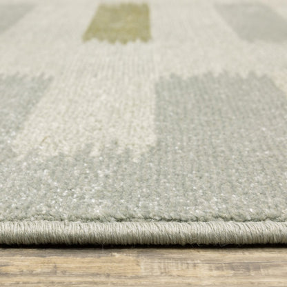 5' X 7' Beige Grey Gold And Green Geometric Power Loom Stain Resistant Area Rug