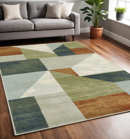 5' X 7' Grey Teal Blue Rust Green And Ivory Geometric Power Loom Stain Resistant Area Rug