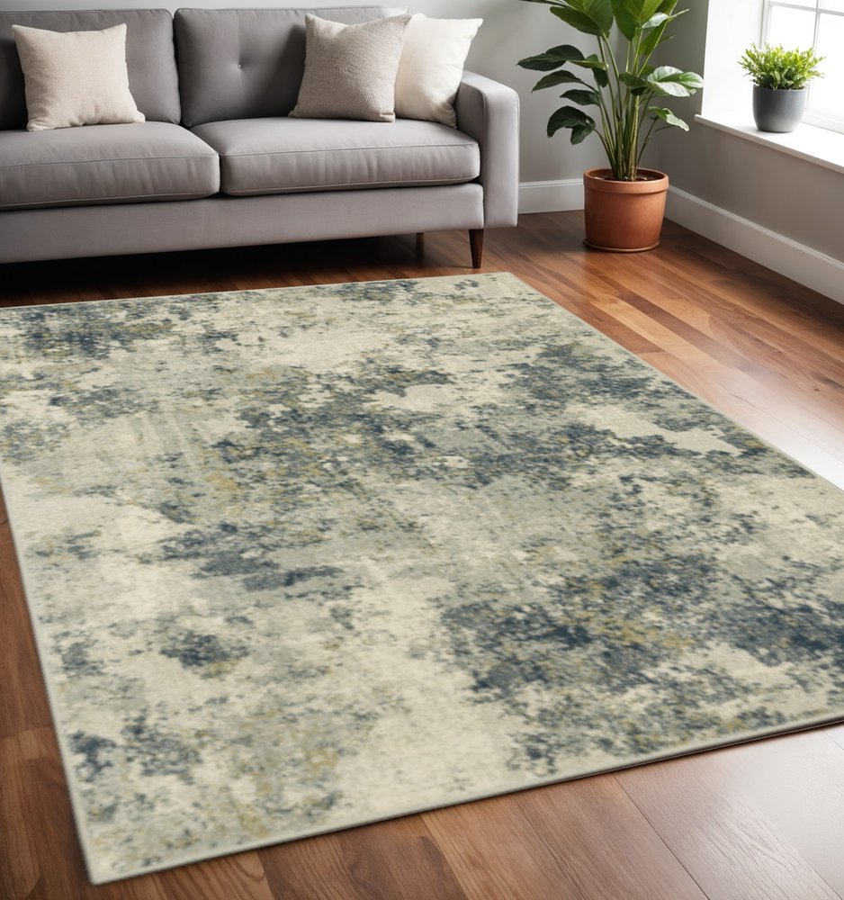 5' X 7' Beige Teal Grey And Gold Abstract Power Loom Stain Resistant Area Rug