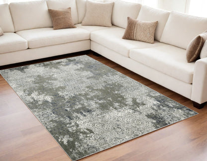 5' X 8' Ivory Grey Blue And Taupe Abstract Power Loom Stain Resistant Area Rug