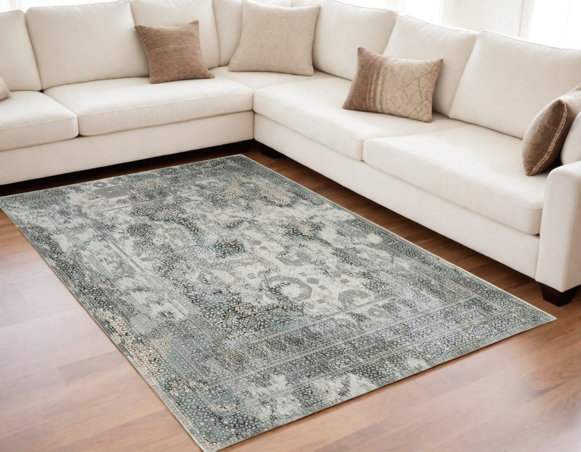 5' X 8' Ivory Grey Charcoal Blue And Rust Oriental Power Loom Stain Resistant Area Rug