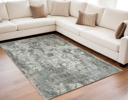 5' X 8' Ivory Grey Charcoal Blue And Rust Oriental Power Loom Stain Resistant Area Rug