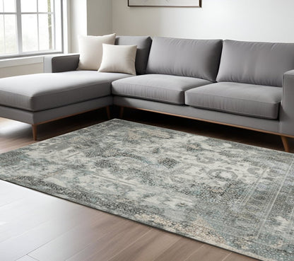 6' X 9' Ivory Grey Charcoal Blue And Rust Oriental Power Loom Stain Resistant Area Rug