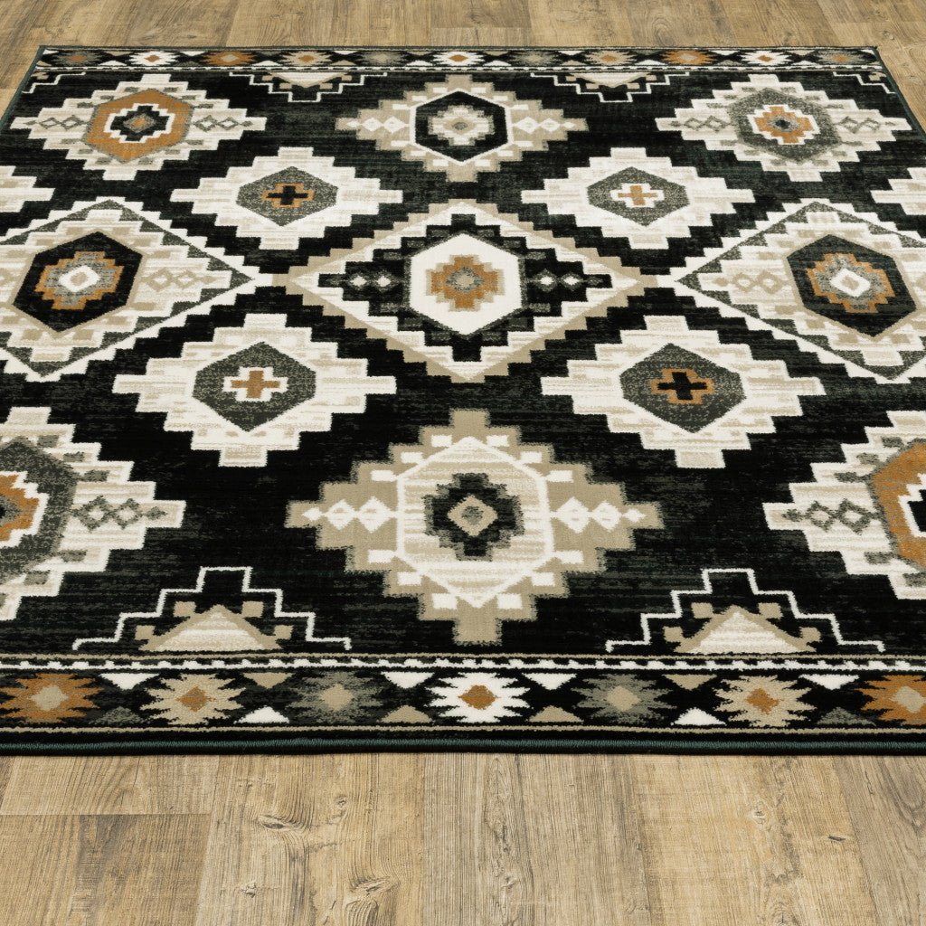 4' X 6' Black Grey Tan Orange And Ivory Southwestern Power Loom Stain Resistant Area Rug