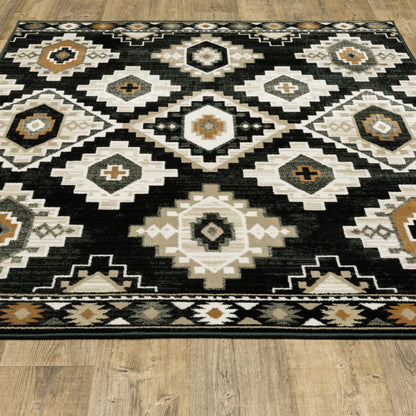 5' X 7' Black Grey Tan Orange And Ivory Southwestern Power Loom Stain Resistant Area Rug