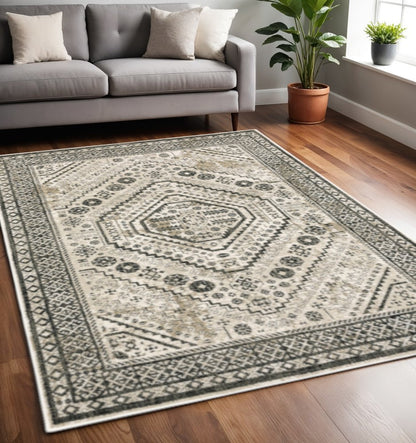 5' X 7' Ivory Grey Black And Ivory Oriental Power Loom Stain Resistant Area Rug