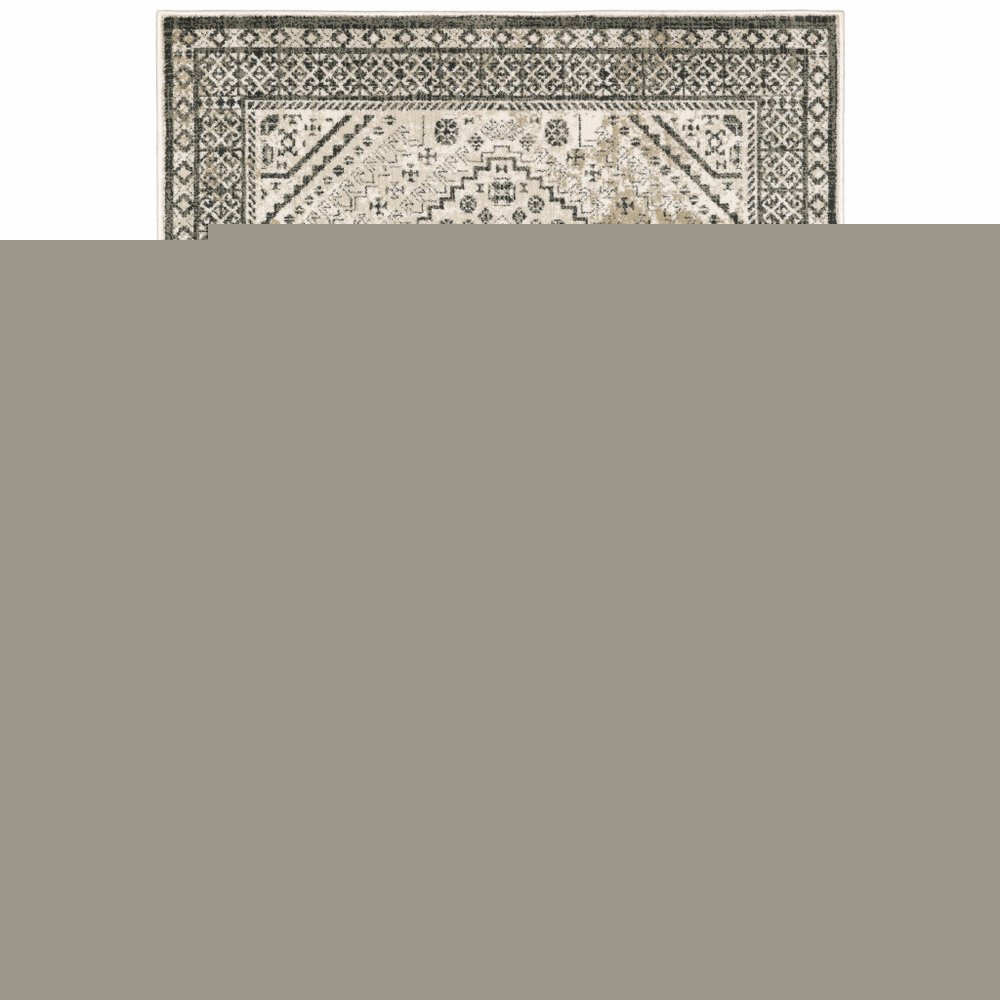 5' X 7' Ivory Grey Black And Ivory Oriental Power Loom Stain Resistant Area Rug