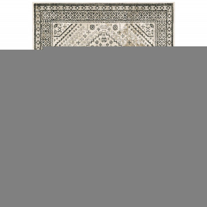 5' X 7' Ivory Grey Black And Ivory Oriental Power Loom Stain Resistant Area Rug