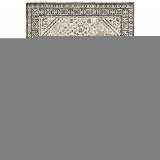 5' X 7' Ivory Grey Black And Ivory Oriental Power Loom Stain Resistant Area Rug