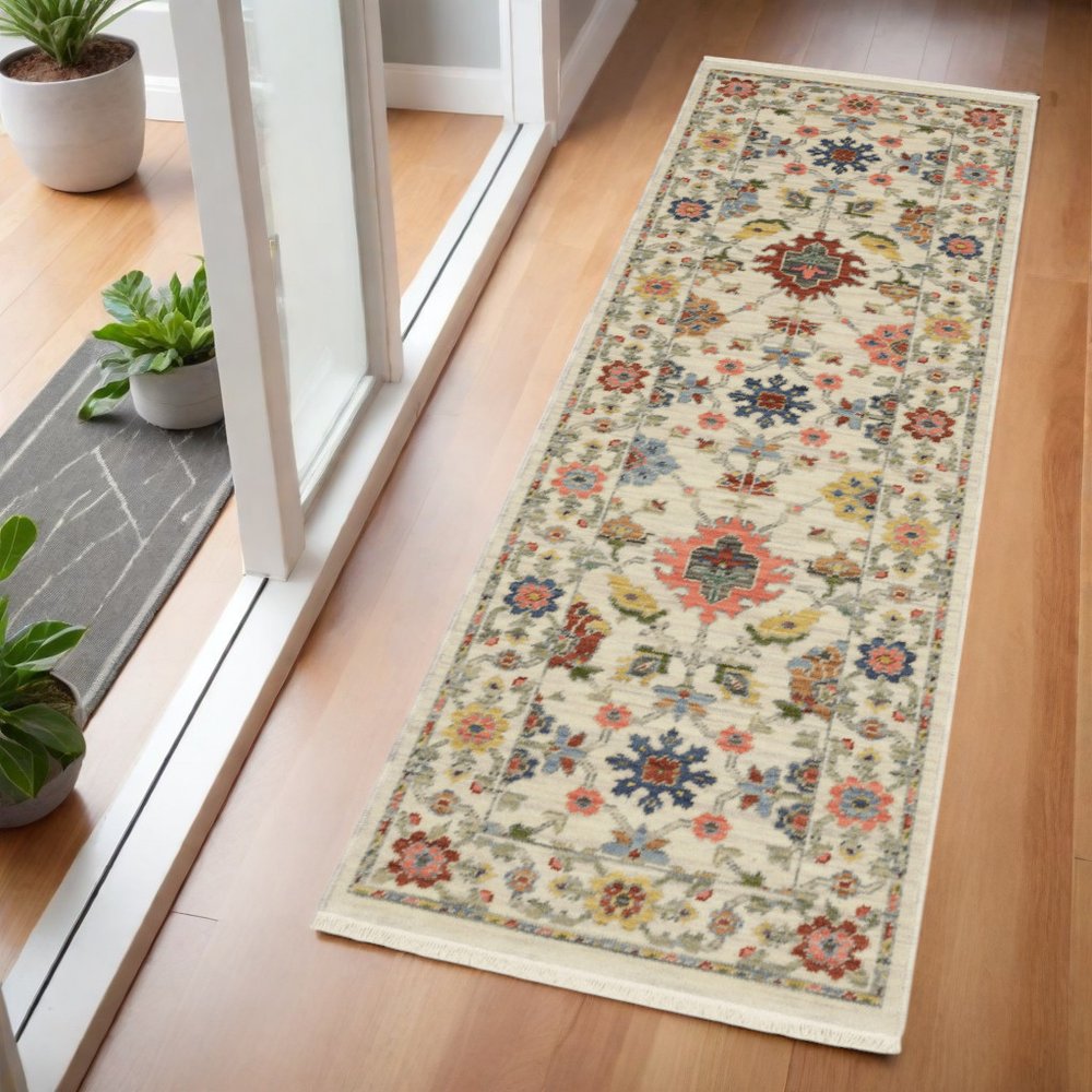 2' X 6' Ivory Salmon Pink Gold Blues Grey Rust And Green Oriental Power Loom Stain Resistant Runner Rug With Fringe