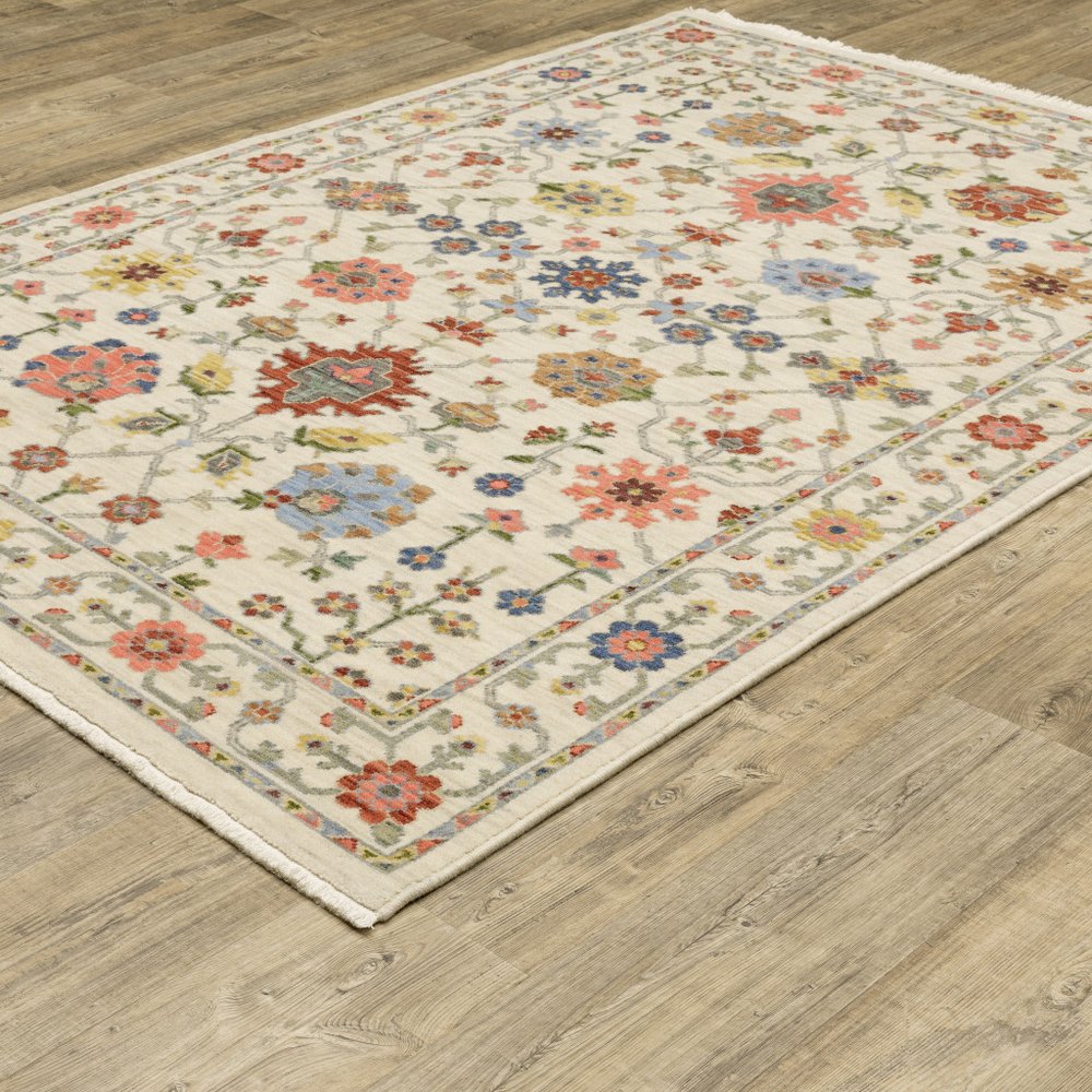 6' X 9' Ivory Salmon Pink Gold Blues Grey Rust And Green Oriental Power Loom Stain Resistant Area Rug With Fringe