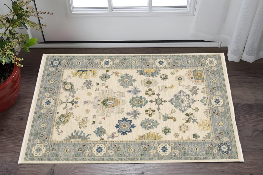 2' X 3' Ivory Blue Grey Teal Gold Green And Rust Oriental Power Loom Stain Resistant Area Rug With Fringe