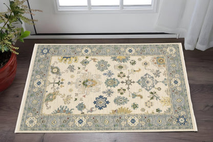 2' X 3' Ivory Blue Grey Teal Gold Green And Rust Oriental Power Loom Stain Resistant Area Rug With Fringe