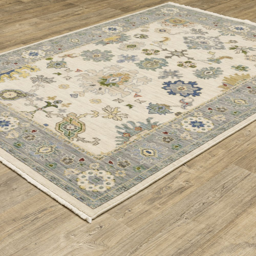 2' X 3' Ivory Blue Grey Teal Gold Green And Rust Oriental Power Loom Stain Resistant Area Rug With Fringe